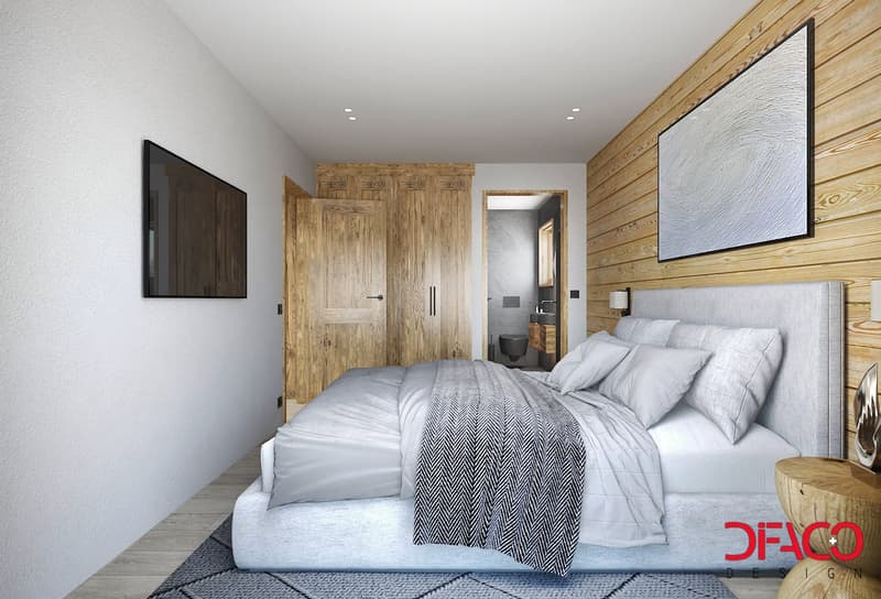 Wooden wall, white bed, gray comforter, pillows, wooden bedside table, wooden cabinets, large monitor, wooden flooring, toilet