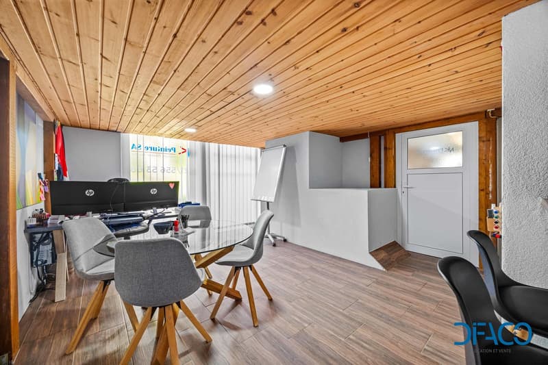 wooden floor, wooden ceiling, glass table, chairs, computer monitors, whiteboard, door
