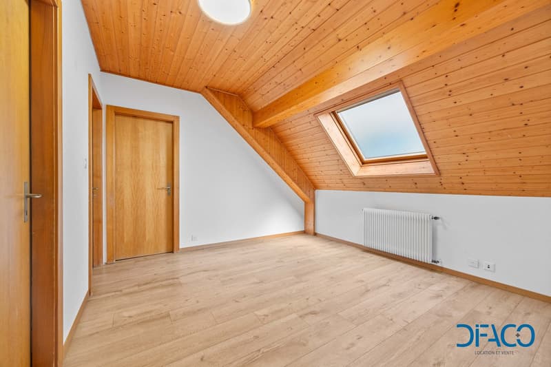 empty room, wooden ceiling, wooden floor, white walls, wooden door, window, radiator