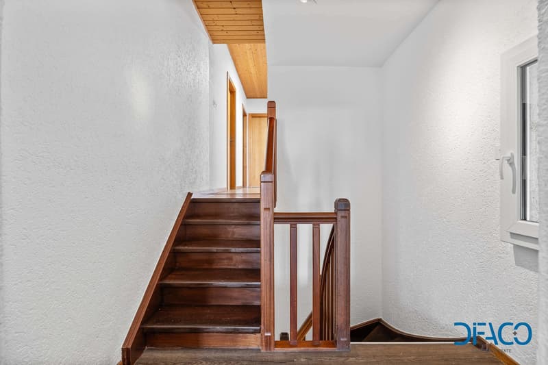 wooden stairs, wooden handrail, white walls, wooden ceiling