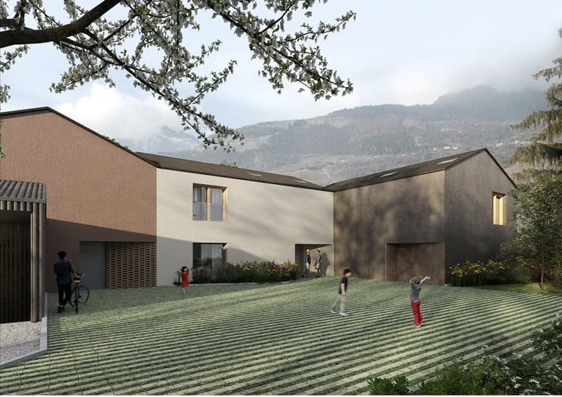 Three story building, light colors, landscaped garden, mountains in the background