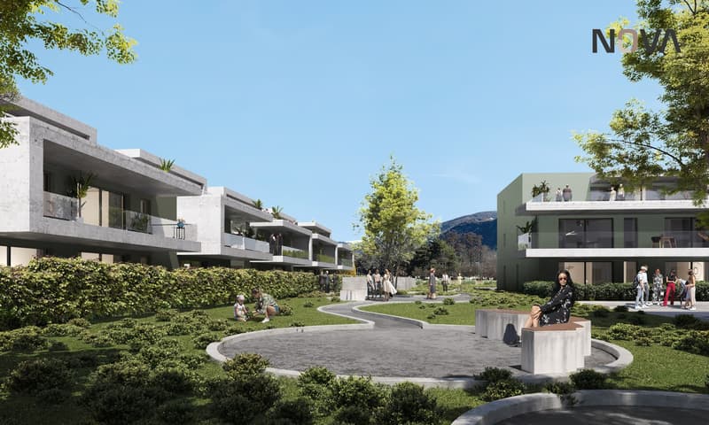 Apartments with several balconies, surrounded by greenery, with a communal pathway