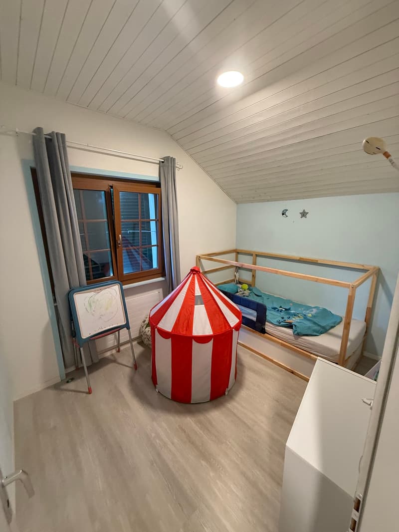 white wooden beams ceiling, wooden floor, gray curtains, wooden bed, tent, drawing board