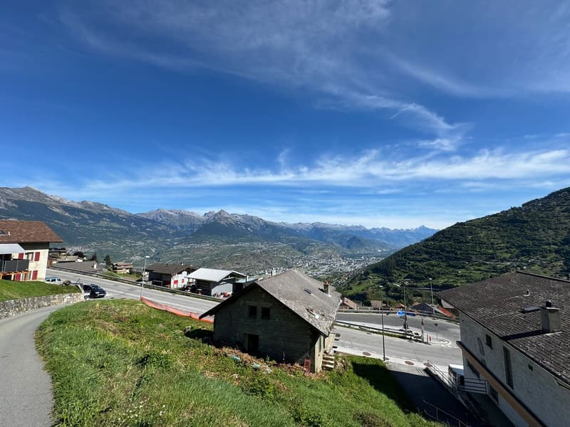 House on the hillside with view of mountains
