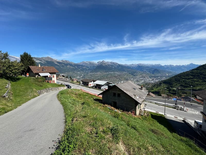 House, on a hillside, near a winding road, with mountains and valley view
