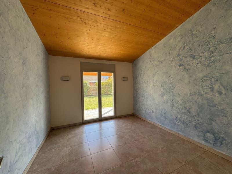 empty room, wooden ceiling, sliding glass door, tiled floor, textured walls