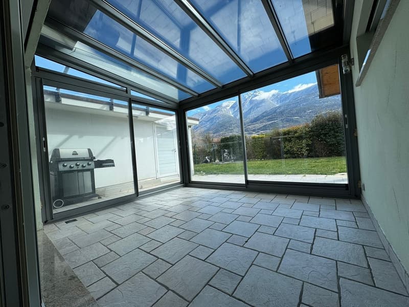 glass walls, tiled floor, outdoor grill, view of mountains