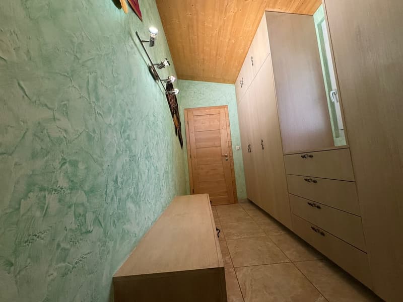 wooden bench, wooden wardrobes, wooden door, green textured wall, wooden ceiling, wall-mounted lights