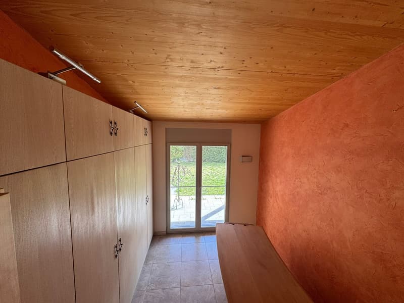 wooden ceiling, wooden wall cabinets, tiled floor, sliding glass door, wooden bench