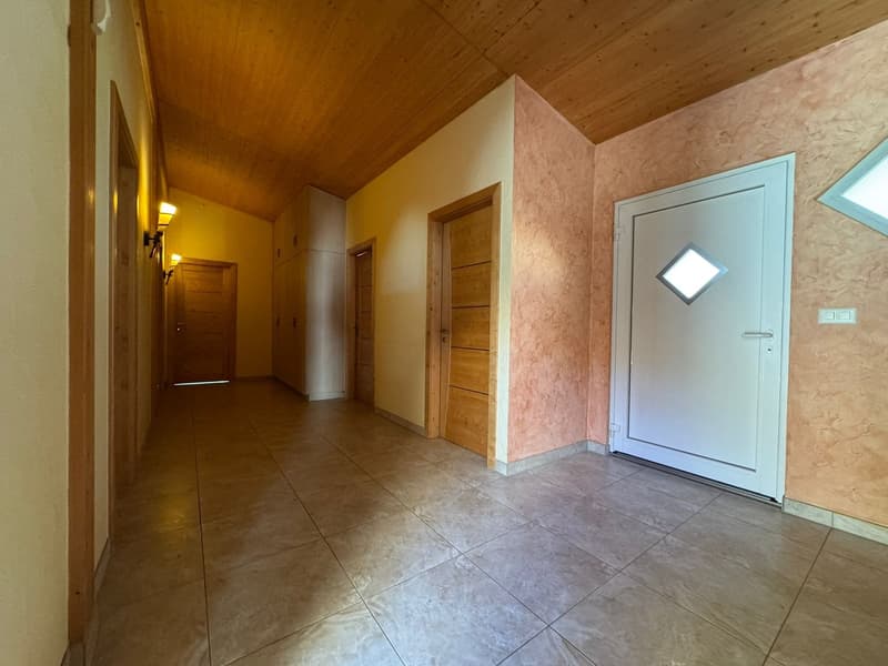tiled floor, wooden ceiling, wooden doors, white door, wall-mounted lights