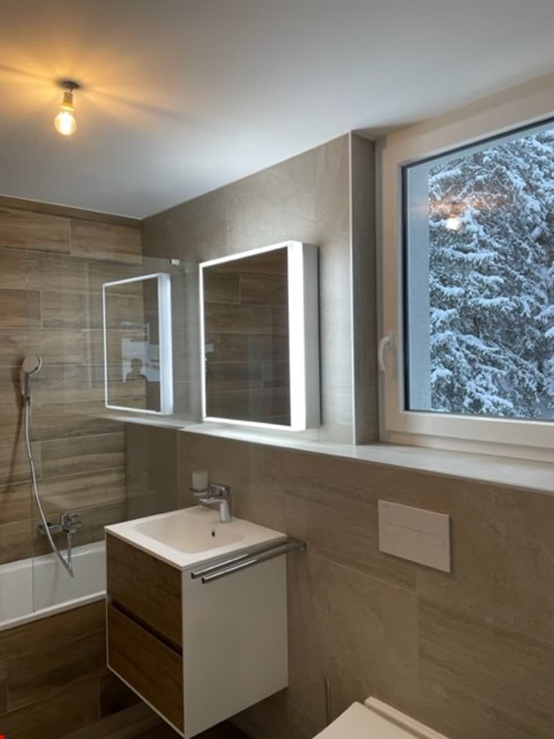 white bathtub, sink, vanity, mirror, tiled wall, window