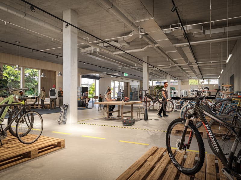 Open layout shop, people are inside and outside, lots of bicycles on display