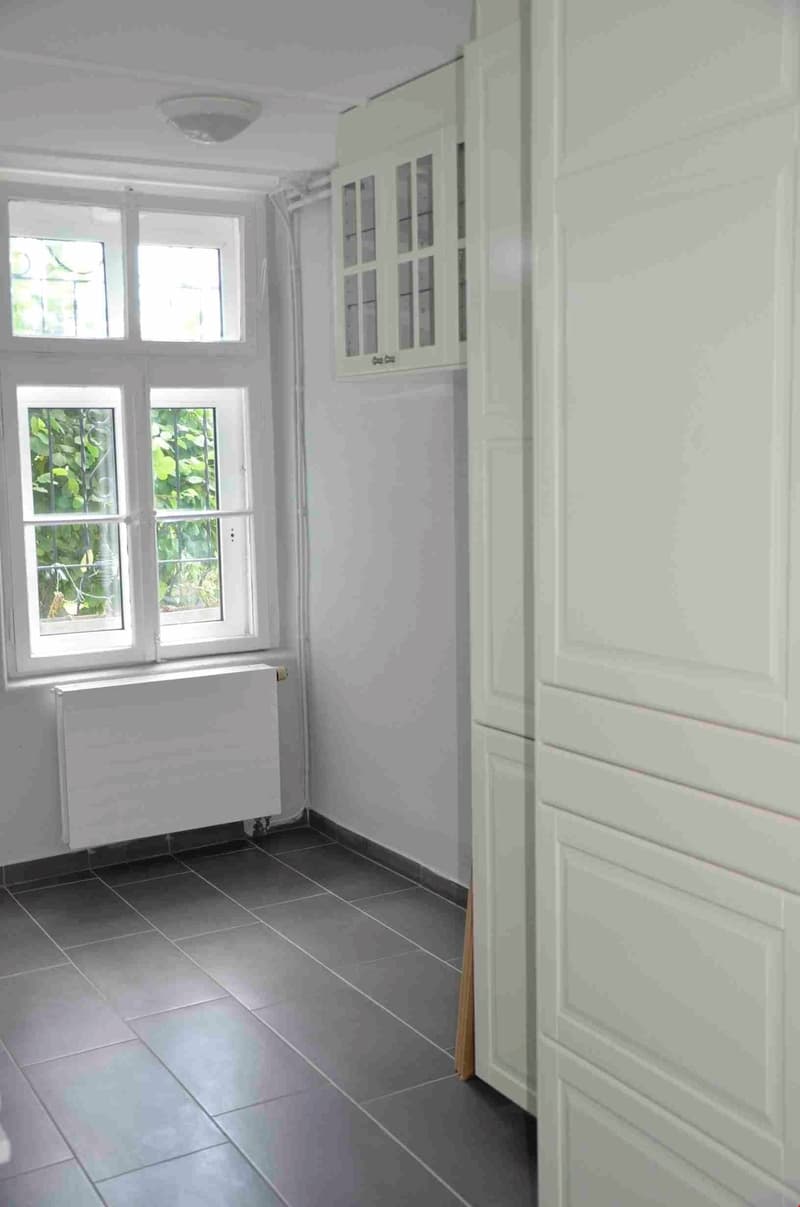 white walls, white ceiling, white floor, white window, white radiator, white cabinets