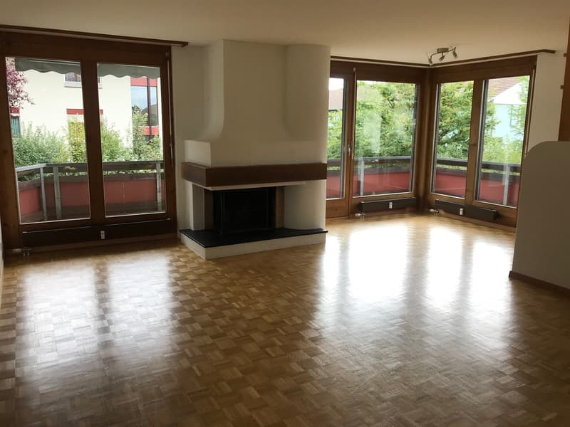 large room, wooden floor, fireplace, large windows, balcony