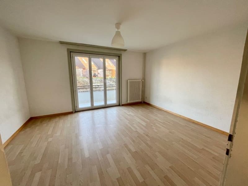 empty room, wooden floor, sliding glass door, white walls, white ceiling, white radiator, white lamp