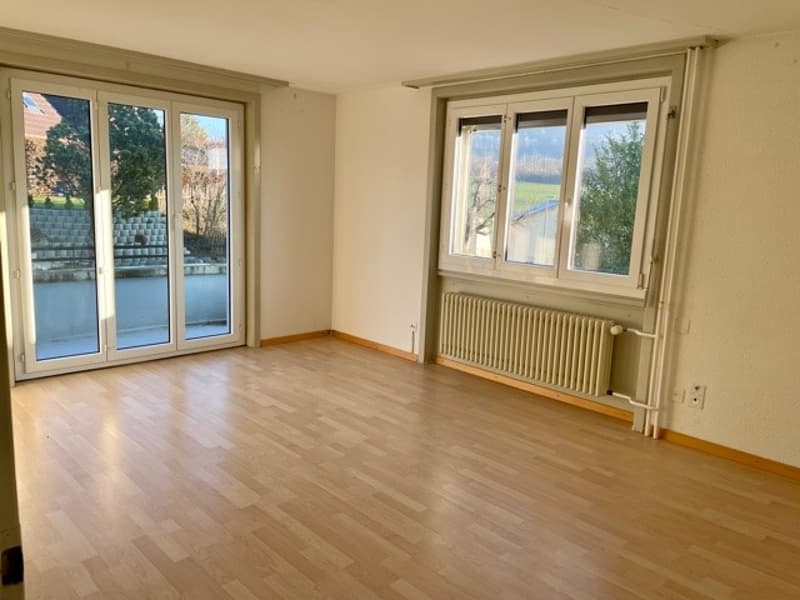 empty room, wooden floor, sliding glass doors, windows, radiator