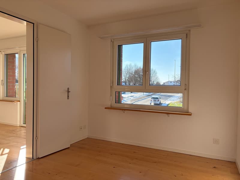 empty room, wooden floor, white walls, large window, power outlets