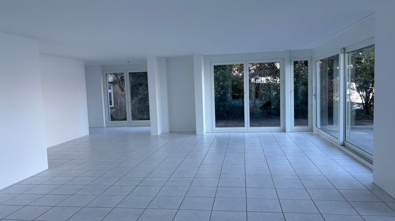 tiled floor, white walls, white sliding glass doors, large windows, empty