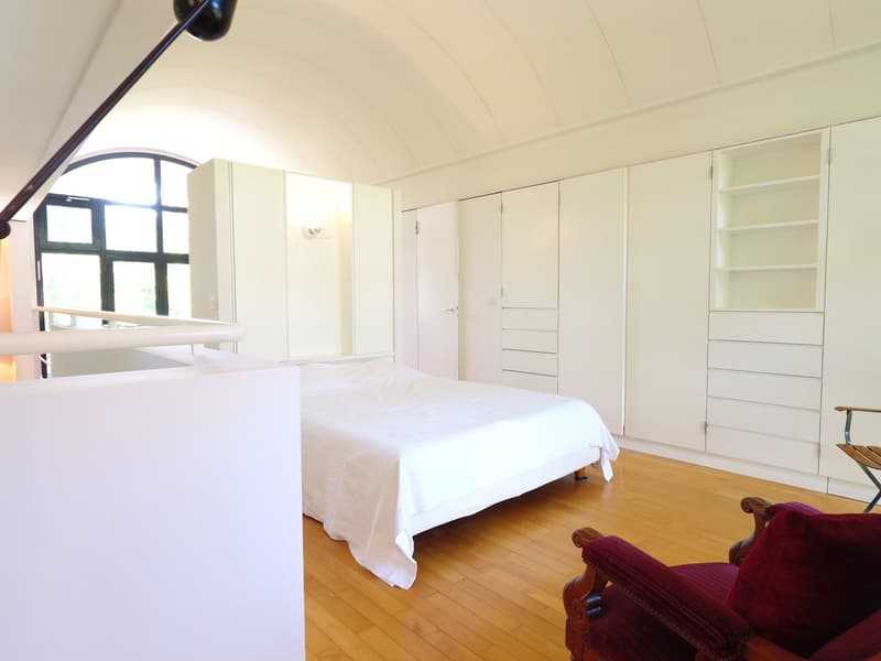bedroom, single bed, white walls, wooden floor, large window, wooden balcony, white storage cupboards