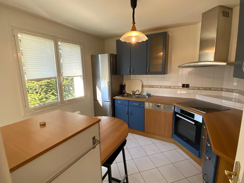 white tiled floor, wooden countertops, blue cabinets, stainless steel fridge, sink with faucet, dishwasher, stove with oven, ceiling lamp
