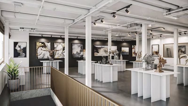 Modern gallery interior with white tables and frames, potted plants, suspended lighting