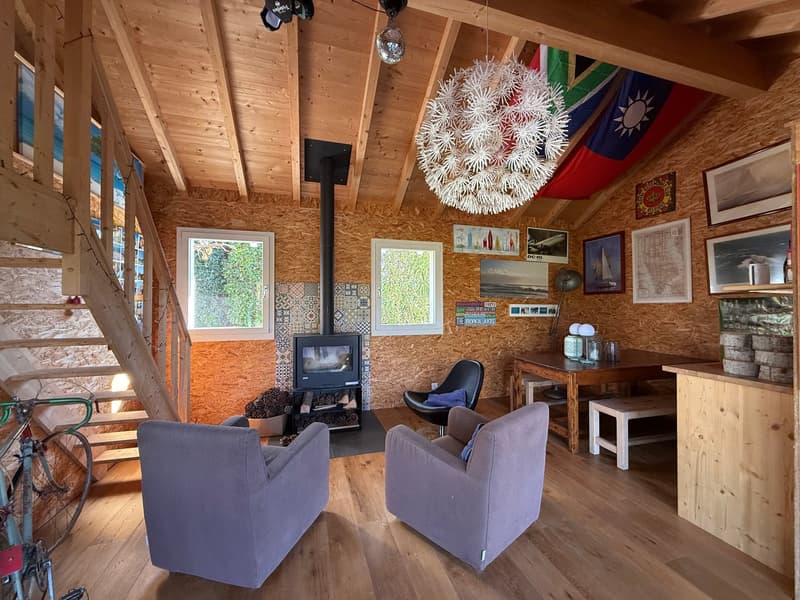 Wooden floor, wooden wall, stairs, fireplace, modern chairs, desk, wooden ceiling, flag