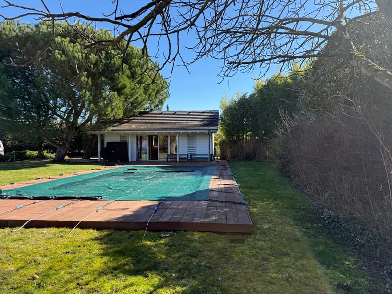 small house, covered pool, wooden deck, greenery