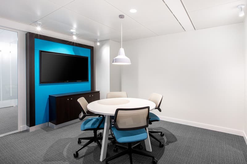 modern room, white walls, blue accent wall, table, chairs, TV, lighting