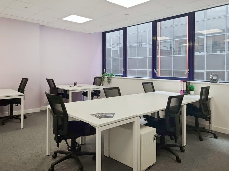 modern office, white tables, black chairs, large windows, plants