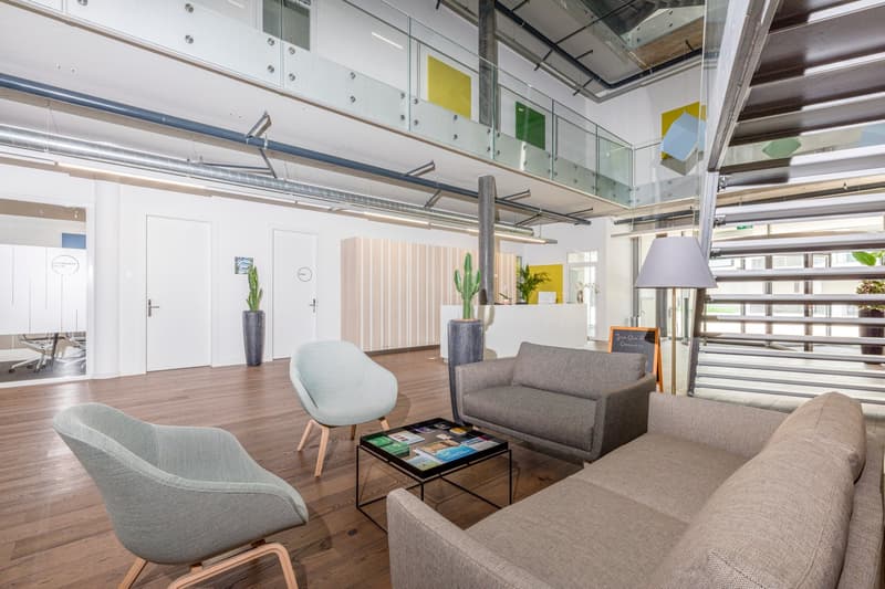 modern design, wood floor, two armchairs, gray sofa, coffee table with magazines, two potted plants