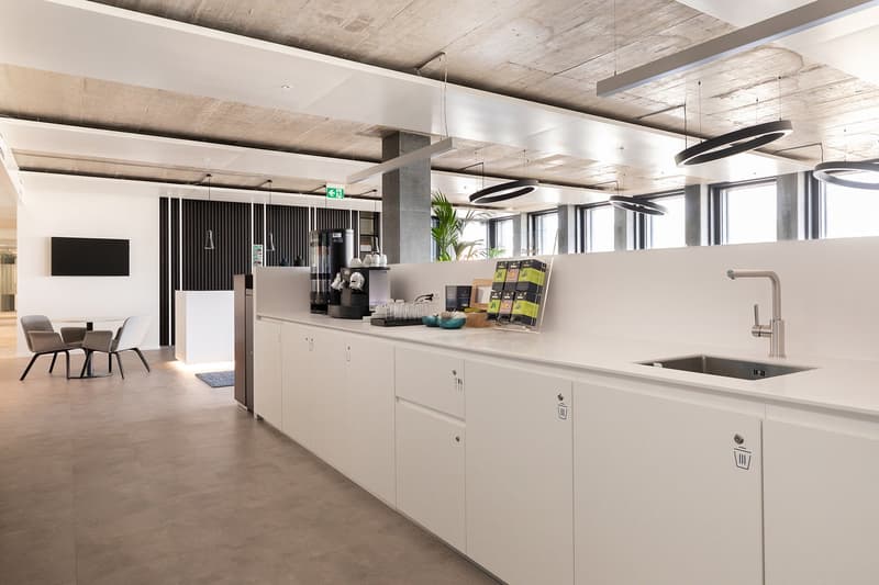 white kitchen area with appliances and a small dining area
