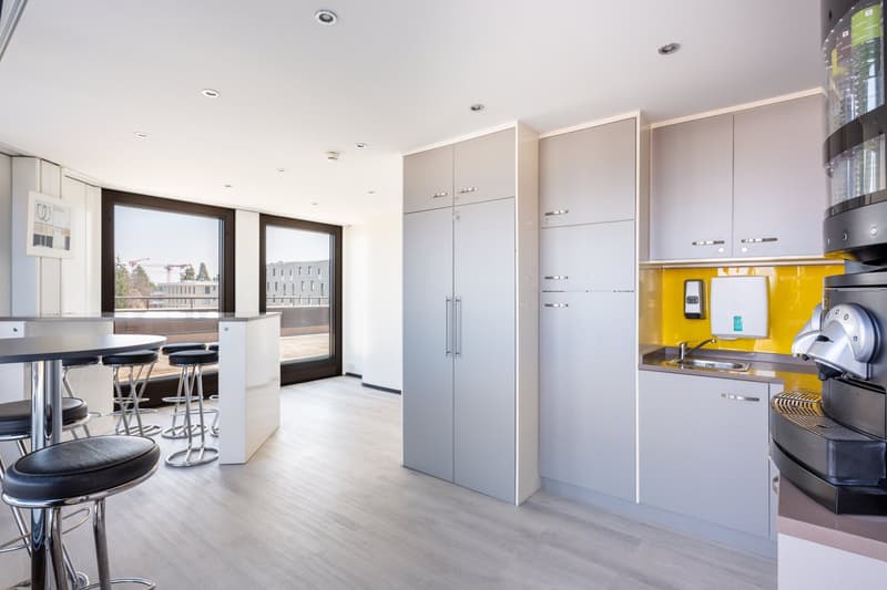 modern kitchen with appliances, large windows with view, open bar, stools