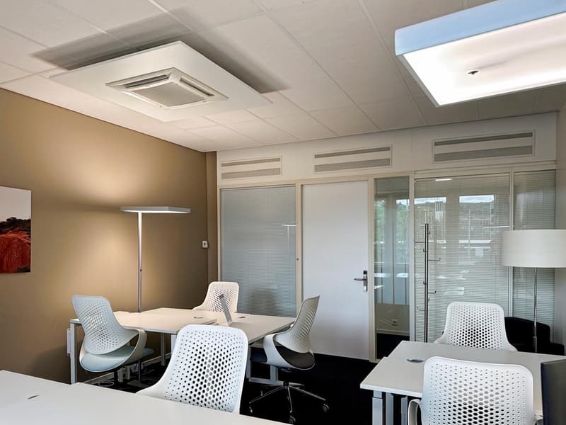 modern office with white desks, white chairs, white lamps, beige wall, glass doors, ceiling lights
