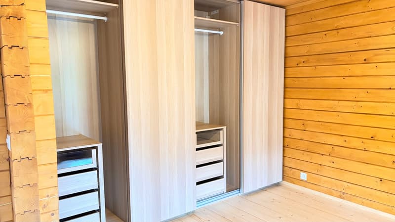 wooden wall, wooden floor, large wardrobe with drawers, sliding doors