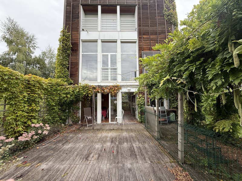 modern house, wooden exterior, glass windows, covered terrace, large garden, metal railings, wooden deck