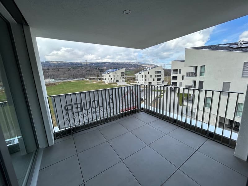 Balcony with a view of the surrounding buildings and landscape, tile flooring on the balcony, metal railing
