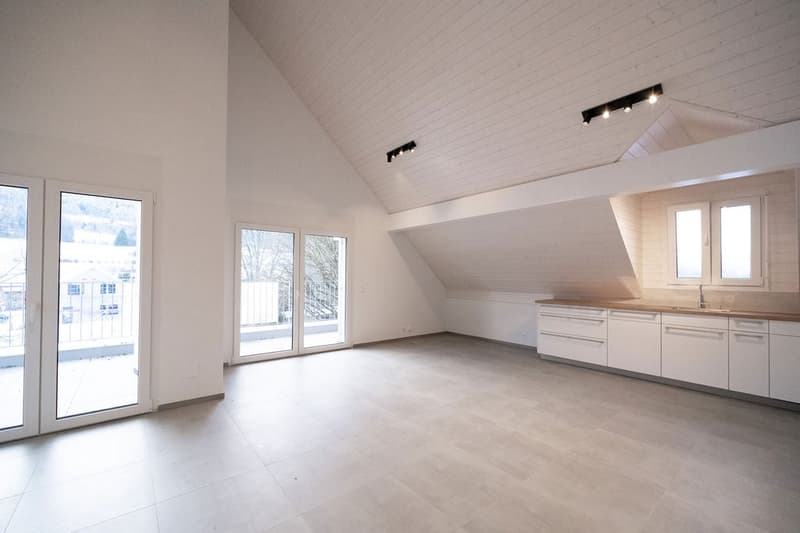 empty kitchen area with sliding doors to balcony, wooden ceiling
