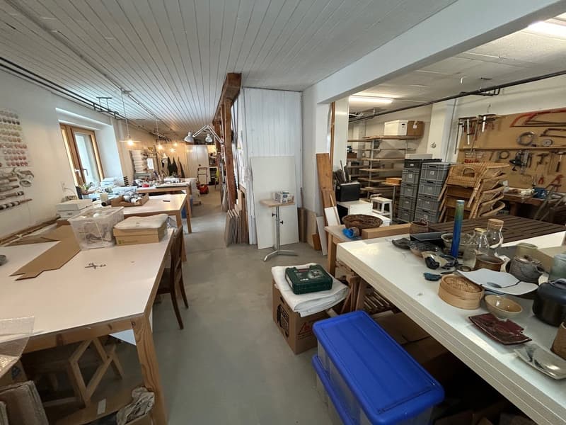 Workshop: wooden tables, various materials, shelves, lamps, various tools