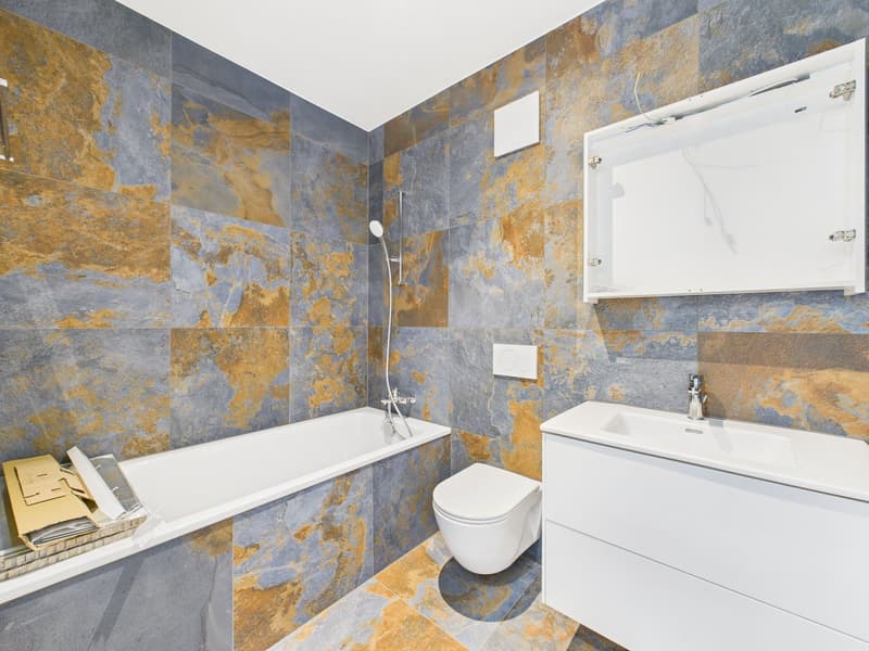 bathroom with bathtub, toilet, sink, shower, decorative tiles, modern fixtures, open space