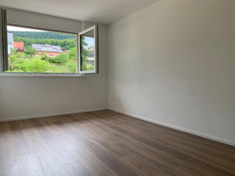 empty room, white walls, wooden floor, large window, electrical outlet, view to the outside