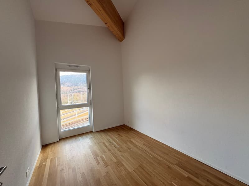 Empty room, large window, wooden floor, white walls, outdoor view