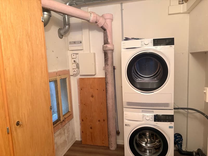 stacked washer and dryer, wooden door, wooden window frame