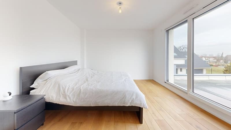 modern bedroom with wooden floor, large windows, bed, nightstand, white walls