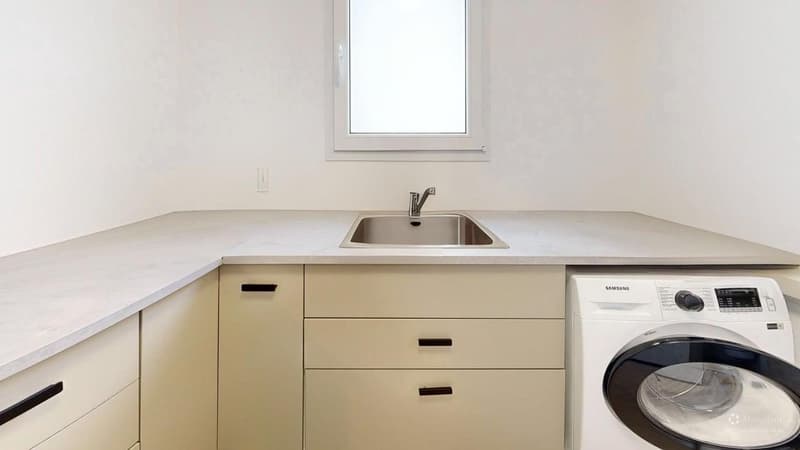 laundry room with sink, washing machine, cabinets, window