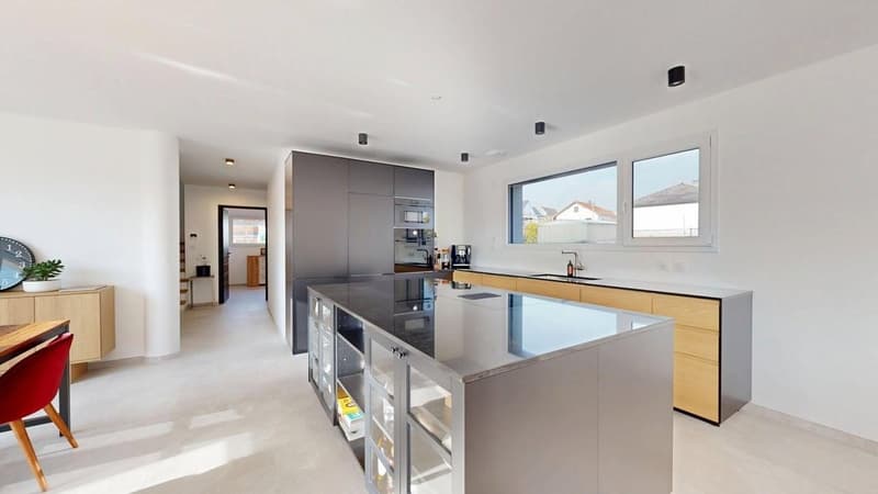 modern kitchen with island, stainless steel appliances, wooden cabinets, large windows, white flooring