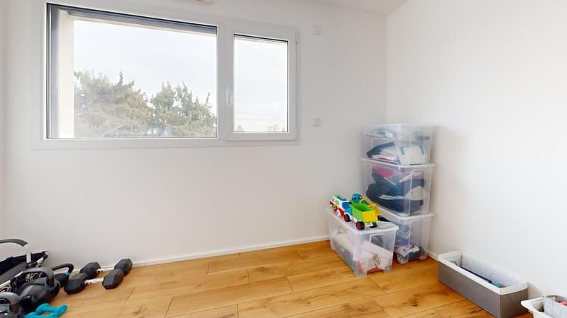 large window, wooden floor, storage boxes, toys, weights