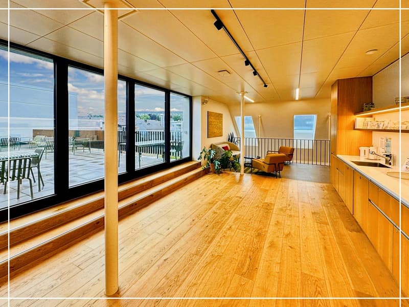 a large open space, hardwood floors, windows, balcony, seating area with couch, table and chairs, sink, and kitchen cabinet