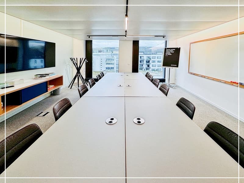 A conference room with a long table, several chairs, whiteboard, TV mounted on wall, and a large window with a city view.
