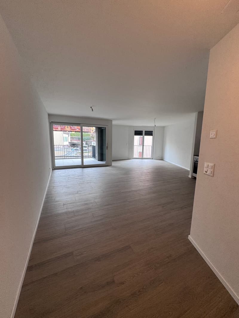 empty room, wooden floor, sliding glass doors, balcony, white walls, power outlets