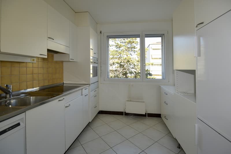 modern kitchen, stainless steel sink, tiled floor, tiled backsplash, white cabinets, oven, dishwasher